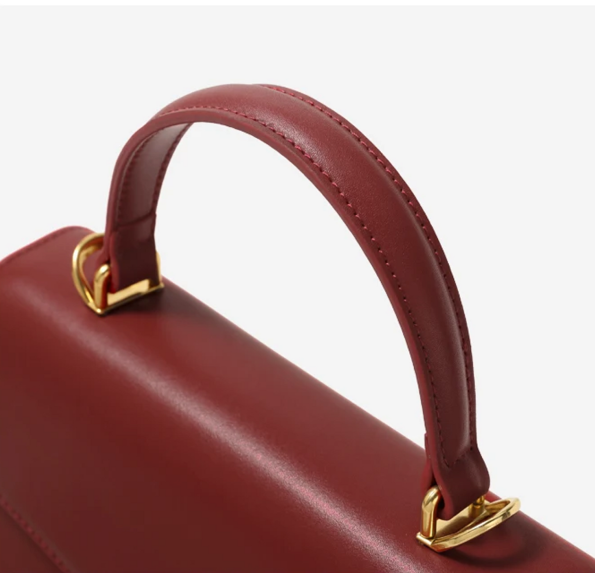 Borsa da donna strutturata con patta e manico superiore