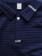 Polo à manches longues texturé pour homme avec fermeture à boutons quart de zip